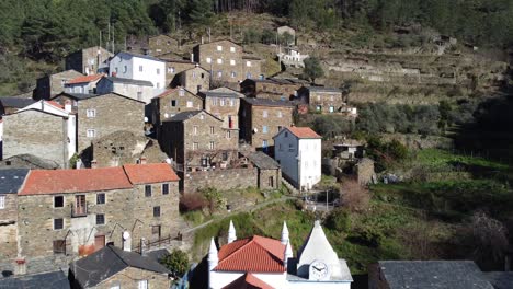 The-beautiful-village-of-Piódão-in-Portugal,-with-houses-made-of-shale-stone---Church