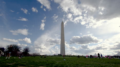 People-on-the-meadow-in-front-of-the-Washington-Monument-with-a-great-cloudscape-in-the-background---an-ultra-wide-shot
