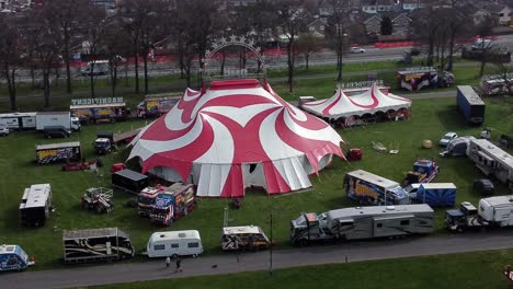 Planet-circus-daredevil-entertainment-colourful-swirl-tent-and-caravan-trailer-ring-aerial-view-rotating-right