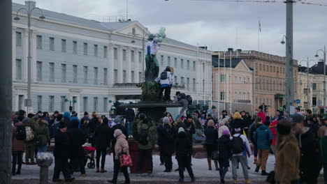 Crowd-gathered-celebrating-Olympic-Ice-hockey-gold-medal,-at-the-market-square,-in-Helsinki,-Finland