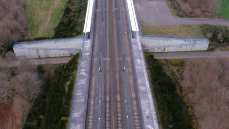 Aerial-Dolly-Back-Over-Empty-Railway-Station-Along-Tracks