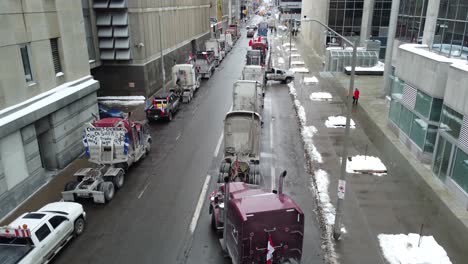 "Freedom-convoy"-truckers-protest-in-Ottawa,-Ontario,-Canada-on-January-31st-2022,-Trucks-and-protesters-block-the-intersection-of-bay-St-and-Wellington-St,-Anti-vaccine-convoy-protests