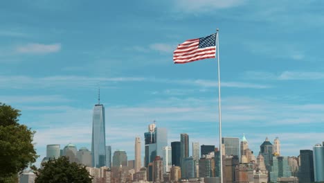 A-still-shot-of-the-american-flag-waving-in-the-wind-with-the-NYC-skyline-in-the-background