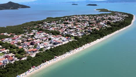 Aerial-drone-view-of-urbanized-tropical-beach-on-peninsula-with-many-summer-houses-facing-the-sea