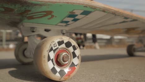A-Skateboard-With-Checkered-Wheels-In-The-Middle-Of-A-Skate-Park