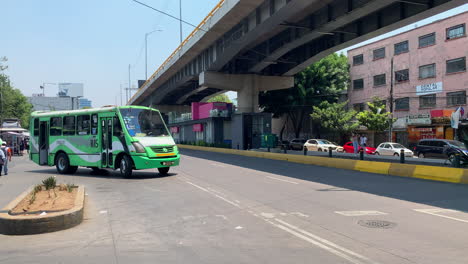 Traditional-Mexican-Green-Public-Transport-Bus-Known-As-La-buseta-Leaving-Bus-Station-In-Beside-Overpass-In-Mexico-City
