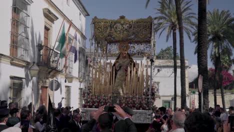 Virgin-Mary-Easter-float-lifted-and-carried-through-crowd,-Jerez,-Spain