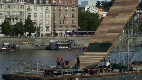 Construction-of-a-ramp-for-extreme-sports-on-a-pontoon-floating-on-the-river-Vltava