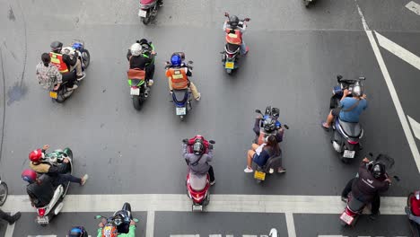 Motorcycle-riders-waiting-at-traffic-light-downtown-Bangkok