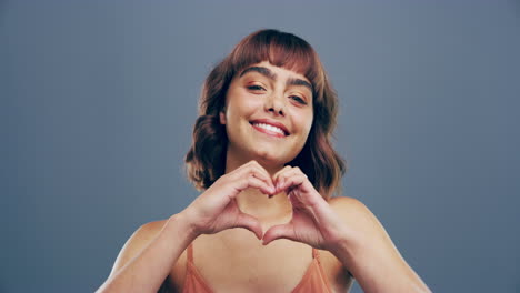 a-young-woman-making-a-heart-shape-with-her-hands