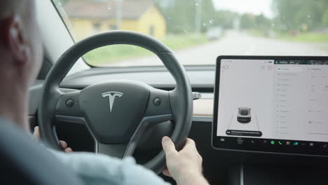 The-interior-control-screen-and-steering-wheel-of-a-Tesla-Model-3