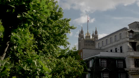 Distant-shot-of-the-Victoria-Tower-with-a-Union-Jack-flag-fluttering-in-the-wind-at-Westminster-Palace-on-14-June-2022