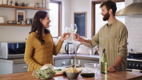 Young-couple-cooking,-drinking-wine