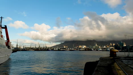 View-over-port-of-Cape-Town,-with-low-clouds-covering-Table-Mountain