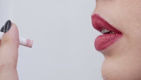 Close-up-profile-view-of-a-beautiful-woman's-lips-as-she-smokes-a-cigarette