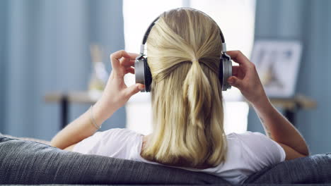 a-young-woman-using-headphones-while-relaxing