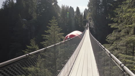 Walking-on-empty-suspension-bridge-with-Canadian-flag