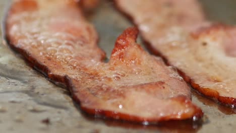Macro-close-up-of-bacon-sizzling-on-a-restaurant-grill