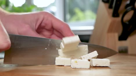 Cutting-feta-cheese-into-small-pieces
