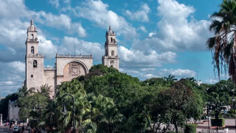 Zooming-in-tight-on-the-cathedral-at-the-Plaza-Grande-as-clouds-swirl-behind-it-in-Merida,-Mexico