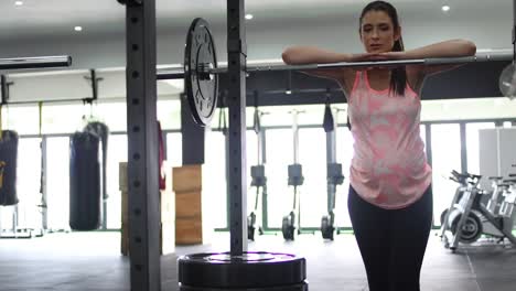 Footage-of-a-pregnant-female-model-doing-squats-in-a-gym-trying-to-keep-fit-in-her-fourth-trimester