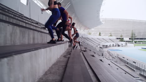 a-group-of-athletes-running-up-a-staircase