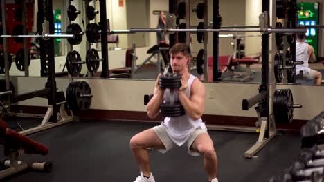 Front-shot-of-young-bodybuilder-doing-goblet-squats