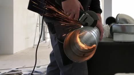 Plumber-uses-an-angle-grinder-to-cut-a-pipe