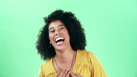 a-confident-young-woman-laughing-against-a-green