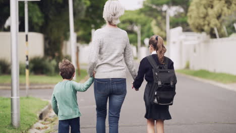 a-senior-woman-walking-her-grandchildren-home