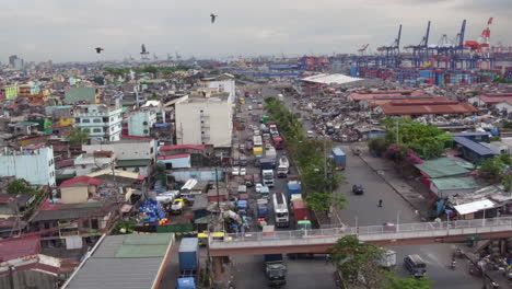 Drone-Shot-Of-A-Busy-Highway-In-A-Squatters-Area-In-Manila-4K