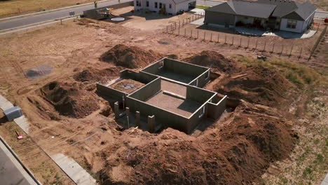 A-drone-shot-slow-push-in-on-a-foundations-and-basement-walls-that-had-just-been-poured