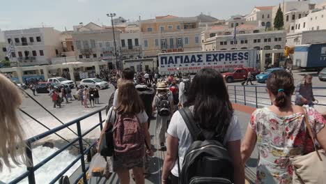 POV-tourists-getting-off-ferry-at-Syros-Harbor