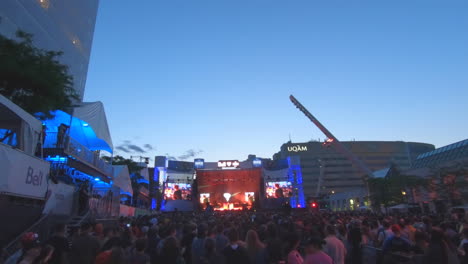 Editorial,-view-of-stage-at-summer-festival,-people-watching-music-show-at-place-des-festivals-Montreal,-beautiful-summer-moments,-francophonies-and-international-jazz-festival