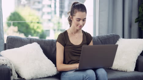 an-attractive-young-woman-using-a-laptop-at-home