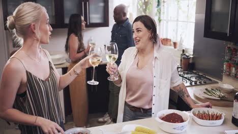 Wine,-kitchen-and-friends-toast-at-a-party-to