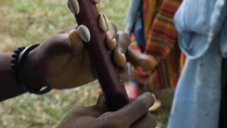 African-Man's-Hand-While-Blowing-Flute,-Close-Up