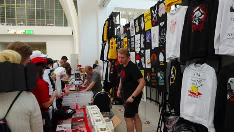 Shop-for-T-shirts-and-souvenirs-with-a-man-burning-with-customers-during-a-meeting-of-anime-and-Japanese-manga-comics-fans-at-the-Animefest-event-in-Brno-at-the-120fps-exhibition-center