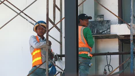 Close-Shot-of-Two-Workmen-on-a-Construction-Site-in-Asia