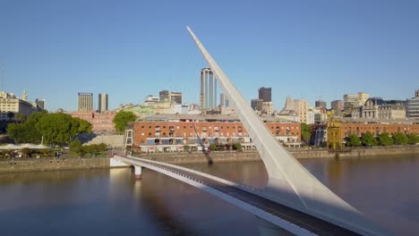 Aerial-rising-over-Puente-de-la-Mujer-and-revealing-downtown-Buenos-Aires