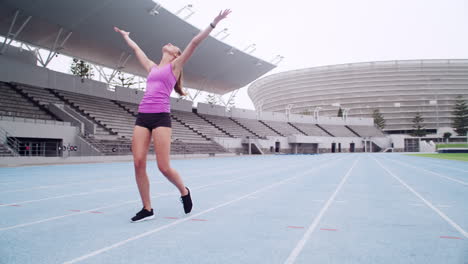 a-female-athlete-cheering-while-out-on-the-track