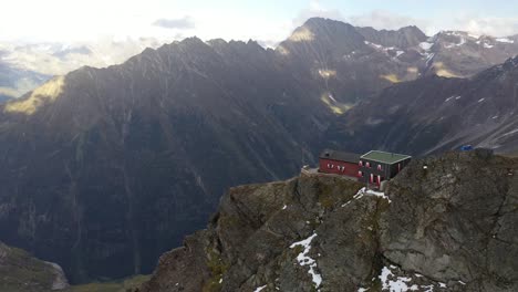 Aerial-shot-of-the-Dossen-Hut-on-top-of-the-mountain,-right-on-the-steep-cliff-in-the-Swiss-Alps