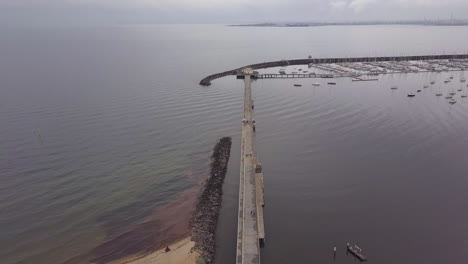 Drone-aerial-view-of-St-Kilda-Pier,-Pan-bottom-to-top,overcast-grey-day-time,-Australia-Melbourne