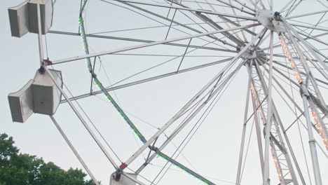 Ferris-wheel-turning-on-summer-night-in-Pennsylvania,-Tilt-Up,-Pan-Right,-Slow-Motion
