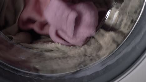 Laundry-going-round-in-a-washing-machine-close-up-shot