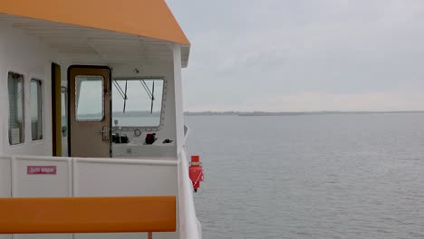 View-On-The-Side-Of-A-Ship-Sailing-On-The-Calm-Sea-In-The-Island-Of-Langeoog-In-Germany---POV-shot