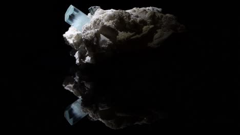 A-single-very-clear-crystal-of-aquamarine-emerges-from-a-feldspar-matrix