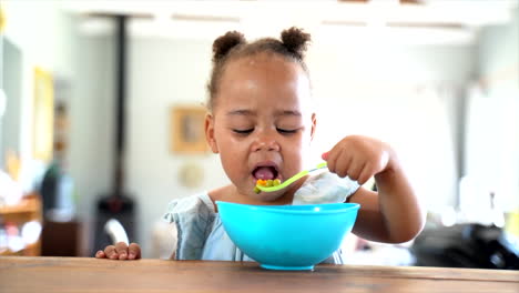 Young-South-African-girl-eating-her-lunch-with-a-blue-bowl