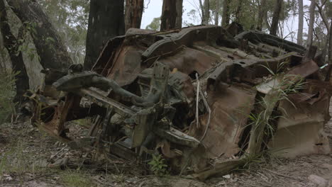 Abandoned-flipped-car-in-Australian-bushland-front-on-low-angle-truck-right