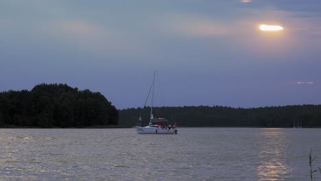 Tourists-enjoying-a-sunset-boat-ride-on-the-waves-of-Wdzydze-Kiszewskie-Poland